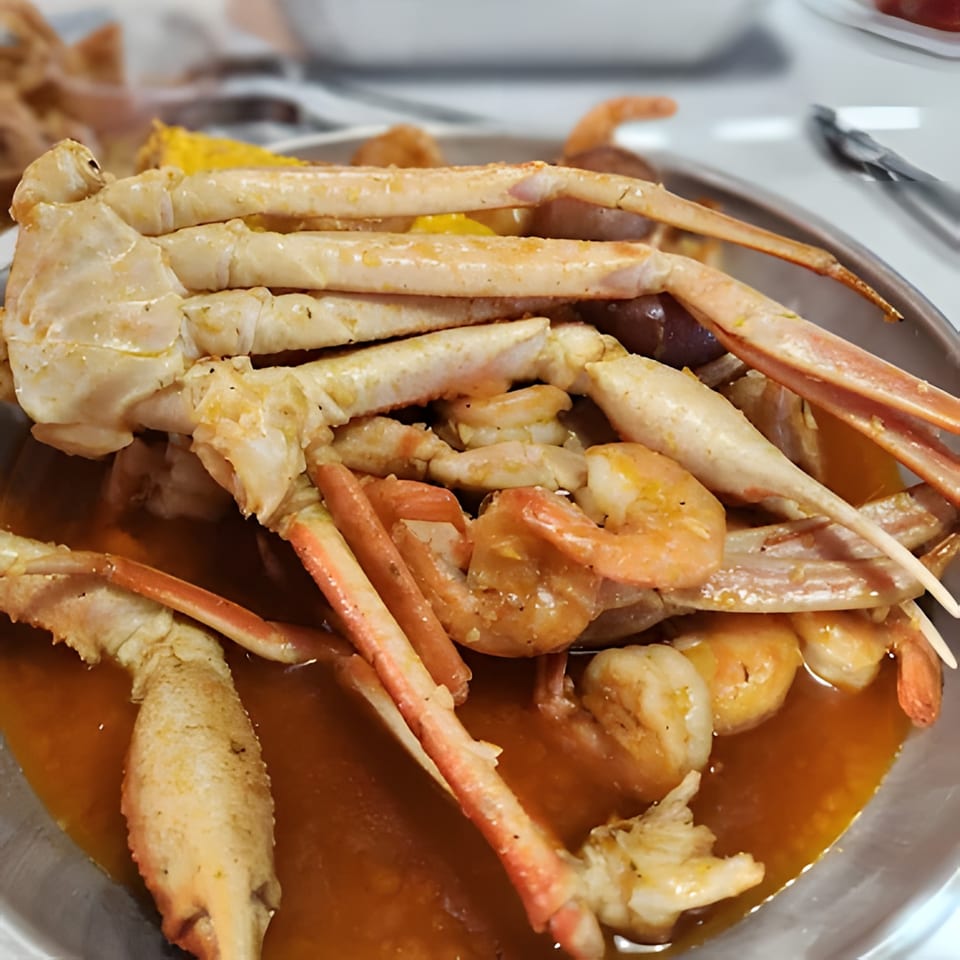 Red Crab Juicy Seafood's snow crab legs and shrimp in a rich, savory sauce.